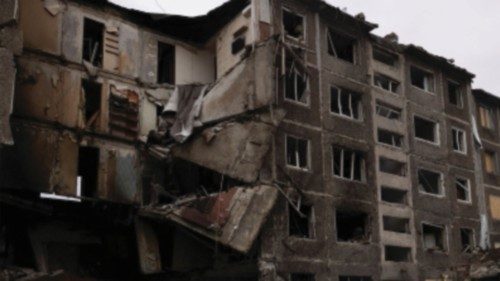 A woman walks past apartment blocks that were destroyed in a Russian missile strike in Selydove near ... A woman walks past apartment blocks that were destroyed in a Russian missile strike in Selydove near ...