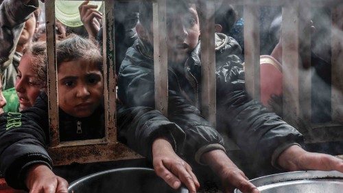 Displaced Palestinian children gather to receive food at a government school in Rafah in the ... Displaced Palestinian children gather to receive food at a government school in Rafah in the ...