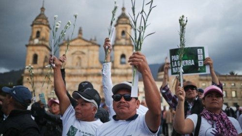 People take part in a sit-in during a demonstration against the murders of signatories of the peace ...
