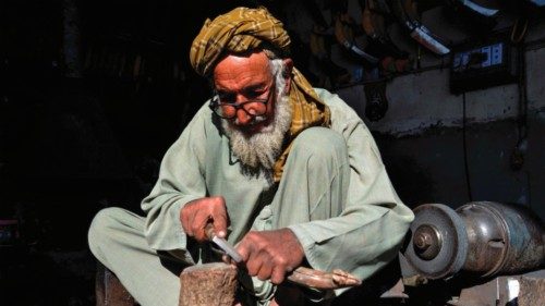 An Afghan blacksmith works on a handle for a tool at a workshop in Kandahar on February 15, 2024. ... An Afghan blacksmith works on a handle for a tool at a workshop in Kandahar on February 15, 2024. ...