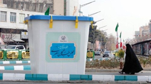 epa11171890 Iranians walk next to a symbol of the election ballot box during the first day of Iran's ... epa11171890 Iranians walk next to a symbol of the election ballot box during the first day of Iran's ...