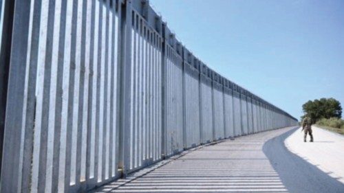 epa09440119 A soldier patrols near a steel fence built along the Evros River in the area of Feres, ... epa09440119 A soldier patrols near a steel fence built along the Evros River in the area of Feres, ...