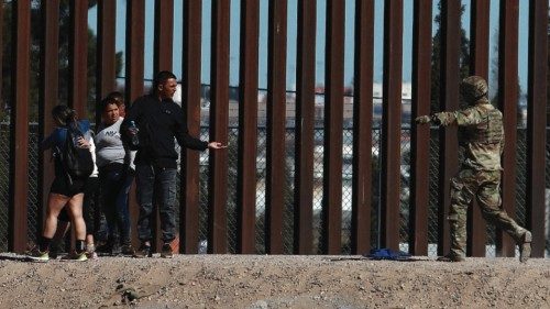 epa11165366 Members of the Texas National Guard prevent the advance of migrants trying to cross the ...