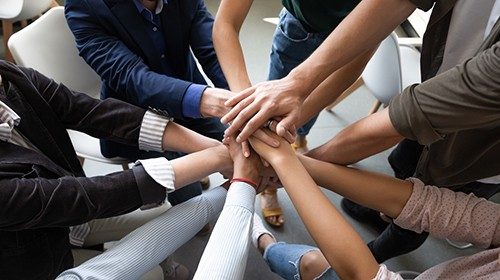 Top close up lot of hands stacked together as symbol concept of teambuilding, loyalty, amity and ... Top close up lot of hands stacked together as symbol concept of teambuilding, loyalty, amity and ...