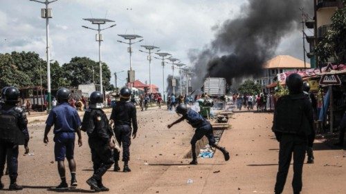 A police officer throws a stone at protesters, during a mass protest the morning after preliminary ... A police officer throws a stone at protesters, during a mass protest the morning after preliminary ...