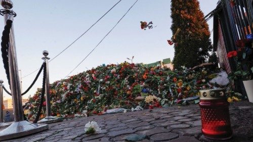 A person throws flowers towards the grave of Russian opposition politician Alexei Navalny while ... A person throws flowers towards the grave of Russian opposition politician Alexei Navalny while ...