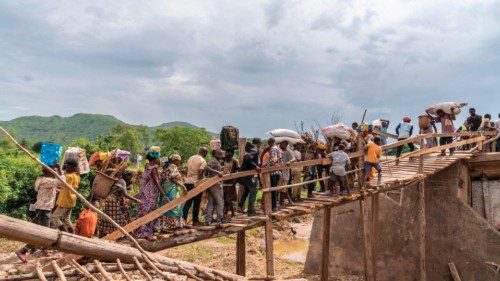 TOPSHOT - Villagers cross a makeshift wooden bridge built over the Shange River after the bridge ... TOPSHOT - Villagers cross a makeshift wooden bridge built over the Shange River after the bridge ...