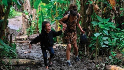 (FILES) A Venezuelan migrant girl is helped by her mother as they arrive at Canaan Membrillo ... (FILES) A Venezuelan migrant girl is helped by her mother as they arrive at Canaan Membrillo ...