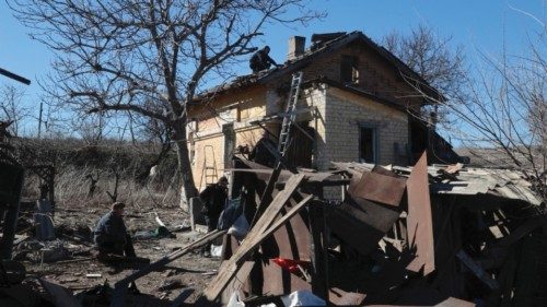 epa11187565 Locals try to repair a damaged private building in Orikhiv, near the frontline in the ...