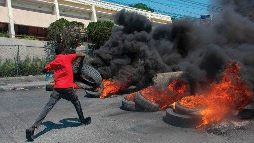 TOPSHOT - A protester burns tires during a demonstration following the resignation of its Prime ... TOPSHOT - A protester burns tires during a demonstration following the resignation of its Prime ...
