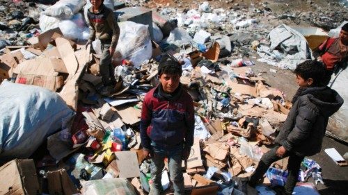 Saleh al-Hussein (C), a 13-year-old displaced Syrian boy, poses for a picture at a rubbish dump in ... Saleh al-Hussein (C), a 13-year-old displaced Syrian boy, poses for a picture at a rubbish dump in ...