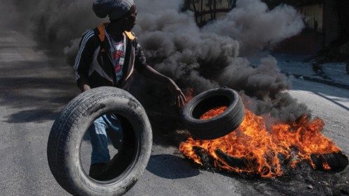 epa11217537 Demonstrators set tires on fire during a protest in Port-au-Prince, Haiti, 12 March ...