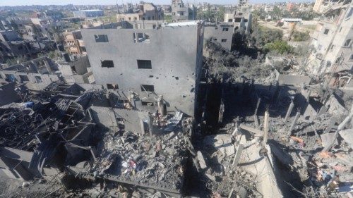 Palestinians inspect the site of an Israeli strike on a residential building, amid the ongoing ... Palestinians inspect the site of an Israeli strike on a residential building, amid the ongoing ...