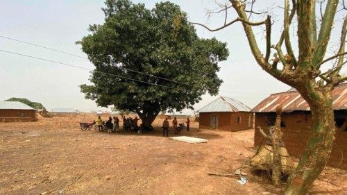 Residents of Tantatu Ward village stand outside their home in the Kajuru Station district on March ... Residents of Tantatu Ward village stand outside their home in the Kajuru Station district on March ...