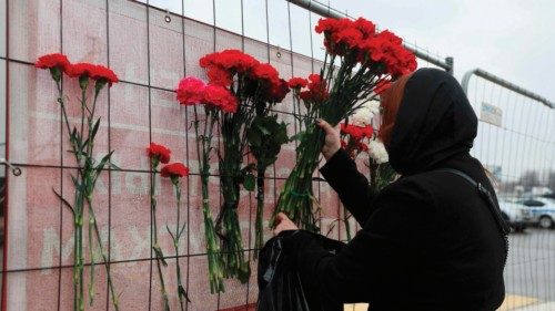 A woman places flowers at a makeshift memorial in front of the Crocus City Hall, a day after a gun ... A woman places flowers at a makeshift memorial in front of the Crocus City Hall, a day after a gun ...
