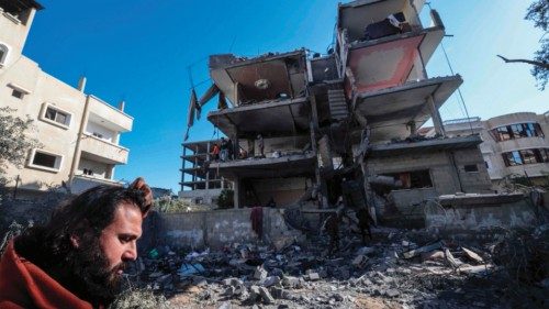 A man inspect the damage to a building after overnight Israeli bombardment in Rafah in the southern ... A man inspect the damage to a building after overnight Israeli bombardment in Rafah in the southern ...