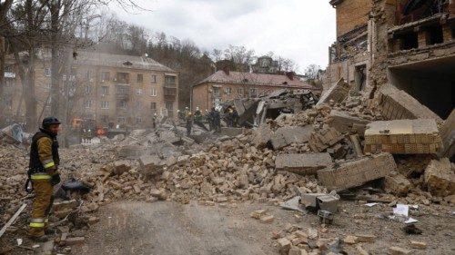 Rescuers work at the site of a building damaged by a Russian missile strike, amid Russia's attack on ...