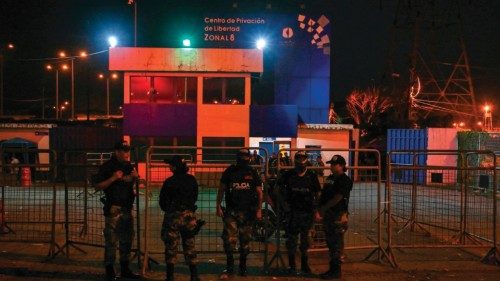 Police officers stand guard outside the Regional 8 prison complex after an 'internal revolt' at the ...