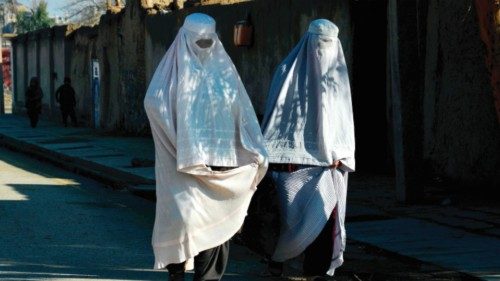 Afghan burqa-clad women walk along a road in Kandahar on March 28, 2024. (Photo by Sanaullah SEIAM / ... Afghan burqa-clad women walk along a road in Kandahar on March 28, 2024. (Photo by Sanaullah SEIAM / ...