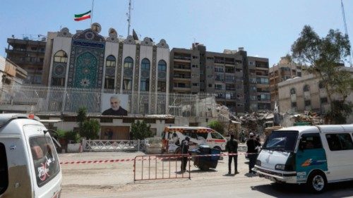 Vahicles drive past the cordoned-off Iranian Embassy building as workers remove the rubble of a ... Vahicles drive past the cordoned-off Iranian Embassy building as workers remove the rubble of a ...