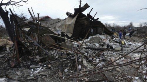 Municipal workers and a police officer inspect remains of a residential building destroyed during a ... Municipal workers and a police officer inspect remains of a residential building destroyed during a ...