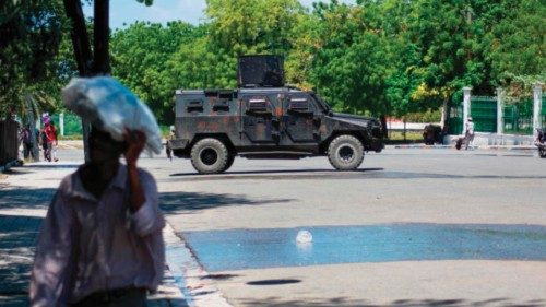 A police vehicle monitors the area near the National Palace in Port-au-Prince, Haiti, on April 2, ...