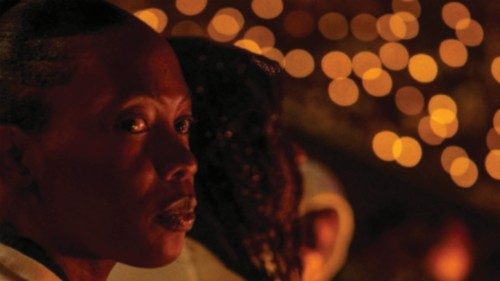 Participants hold a candle light night vigil during a commemoration event, known as 'Kwibuka' ...