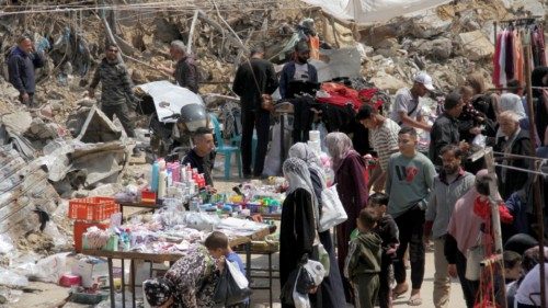 Palestinians shop as they prepare for the upcoming holiday of Eid al-Fitr, marking the end of the ... Palestinians shop as they prepare for the upcoming holiday of Eid al-Fitr, marking the end of the ...
