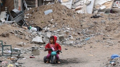 TOPSHOT - A Palestinian child plays near a building destroyed by earlier Israeli bombardment in Gaza ... TOPSHOT - A Palestinian child plays near a building destroyed by earlier Israeli bombardment in Gaza ...