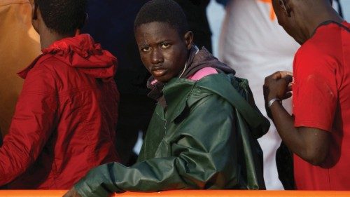 Migrants wait to disembark from a Spanish coast guard vessel, in the port of Arguineguin, on the ... Migrants wait to disembark from a Spanish coast guard vessel, in the port of Arguineguin, on the ...