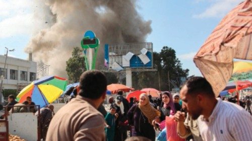 TOPSHOT - Palestinians look at smoke billowing during Israeli bombardment on the Firas market area ...