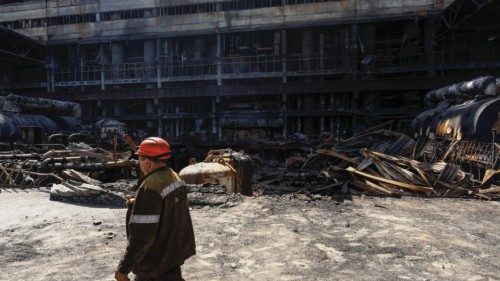 An employee walks at a thermal power plant heavily damaged by recent Russian missile strikes, amid ...