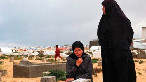 A woman cries over the grave of a loved one at the start of the Eid al-Fitr festival, marking the ... A woman cries over the grave of a loved one at the start of the Eid al-Fitr festival, marking the ...