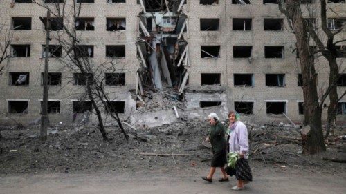 TOPSHOT - Elderly women walk past a hostel destroyed during a missile attack in the town of ... TOPSHOT - Elderly women walk past a hostel destroyed during a missile attack in the town of ...