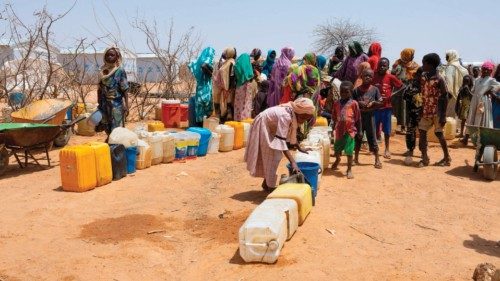 Sudanese refugees gather to get water from a water point in the Farchana refugee camp, on April 8, ... Sudanese refugees gather to get water from a water point in the Farchana refugee camp, on April 8, ...