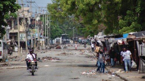 epa11264734 Inhabitants walk in a street in downtown Port au Prince, Haiti, 07 April 2024. The ...