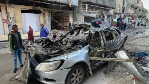 Onlookers check the car in which three sons of Hamas leader Ismail Haniyeh were reportedly killed in ...