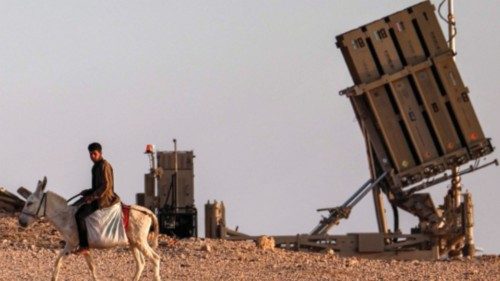 TOPSHOT - A boy rides a donkey near one of the batteries of Israel's Iron Dome missile defence ... TOPSHOT - A boy rides a donkey near one of the batteries of Israel's Iron Dome missile defence ...