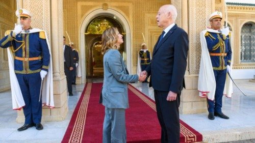 A picture provided by the Tunisian presidency shows President Kais Saied welcoming Italian Prime ...