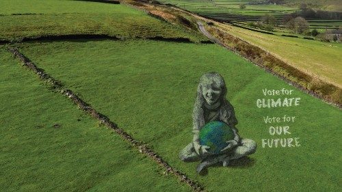 A drone view of a large-scale land art piece by local artists Sand In Your Eye of a girl holding the ... A drone view of a large-scale land art piece by local artists Sand In Your Eye of a girl holding the ...