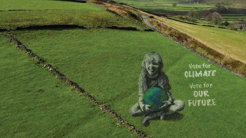 A drone view of a large-scale land art piece by local artists Sand In Your Eye of a girl holding the ...