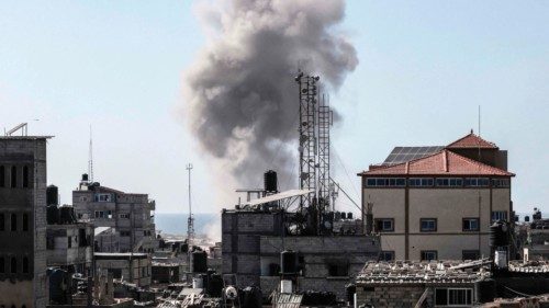Smoke rises above buildings during Israeli bombardment in Rafah in the southern Gaza Strip on April ...