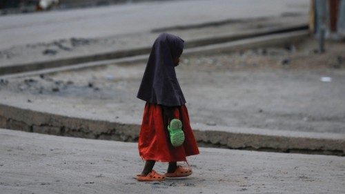A girl carrying an extra pair of slippers, walks along the road in Maiduguri, Nigeria April 8, 2024. ... A girl carrying an extra pair of slippers, walks along the road in Maiduguri, Nigeria April 8, 2024. ...
