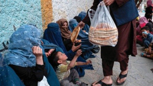 Afghan women collect free bread from a charity during the holy fasting month of Ramadan in Kabul on ...