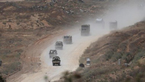 epa11297706 Israeli troops patrol the road that separates northern and southern Gaza Strip, as seen ...