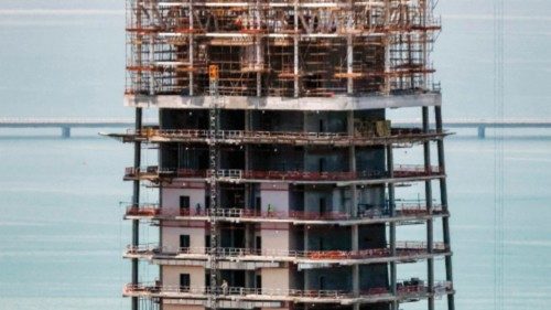 This picture taken from the National Bank of Kuwait (NBK) headquarters shows workers walking at the ... This picture taken from the National Bank of Kuwait (NBK) headquarters shows workers walking at the ...