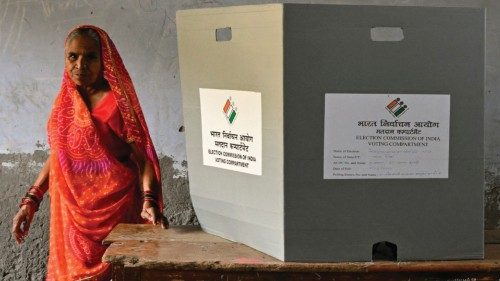 A voter walks after casting her ballot at a polling station during the third phase of voting of ... A voter walks after casting her ballot at a polling station during the third phase of voting of ...