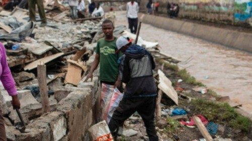 Residents scavenge metal sheets and wooden poles from shanties that have been demolished by the ... Residents scavenge metal sheets and wooden poles from shanties that have been demolished by the ...