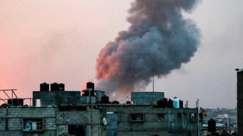 Smoke rises above buildings during an early morning Israeli strike on Rafah in the southern Gaza ...
