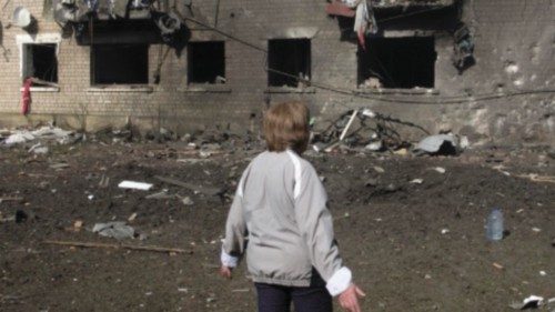 epa11333857 Tetyana looks at a building damaged during recent shelling on the outskirts of Volchans, ...